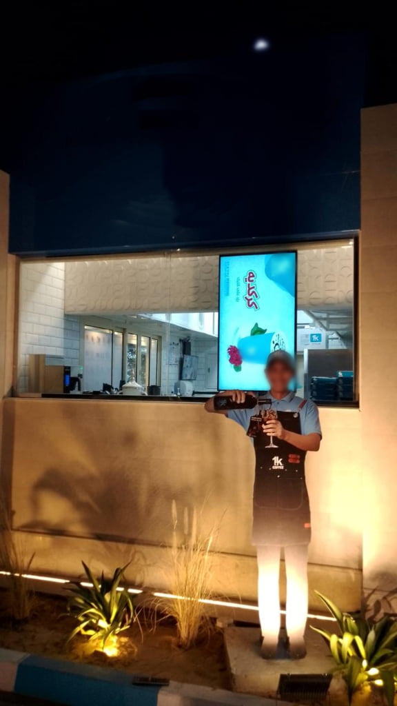 High brightness digital signage display in retail storefront window with sunlight readable LCD screen technology