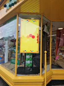 commercial digital signage window display with high brightness LCD screen for nighttime retail advertising and storefront marketing