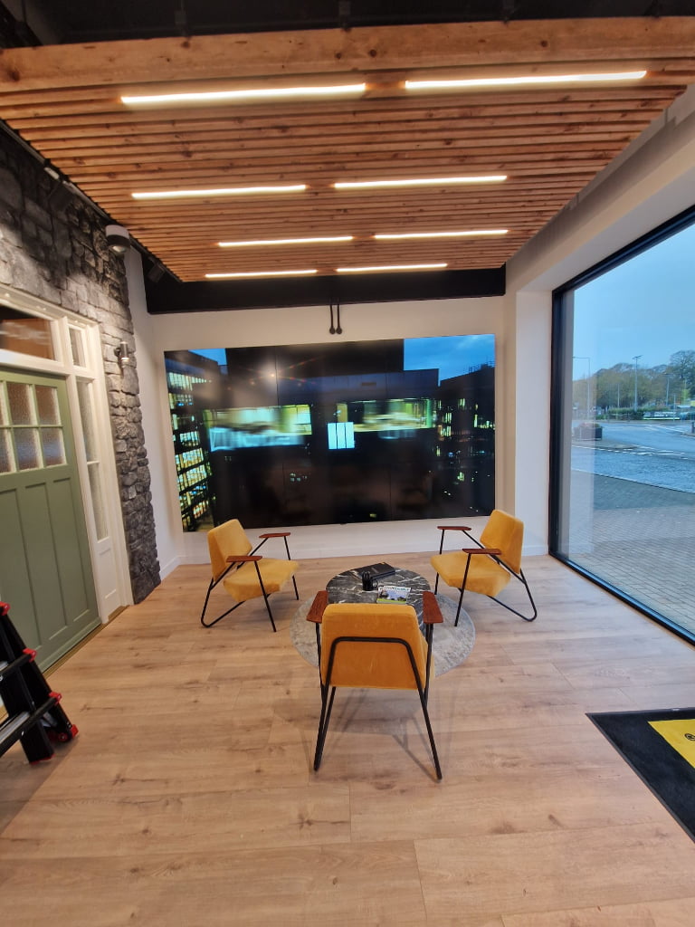 Modern retail showroom featuring large format commercial display and interactive video wall with contemporary interior design