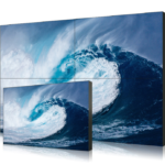 LCD video wall display with ultra-narrow bezel showing seamless 2x2 screen array with wave imagery