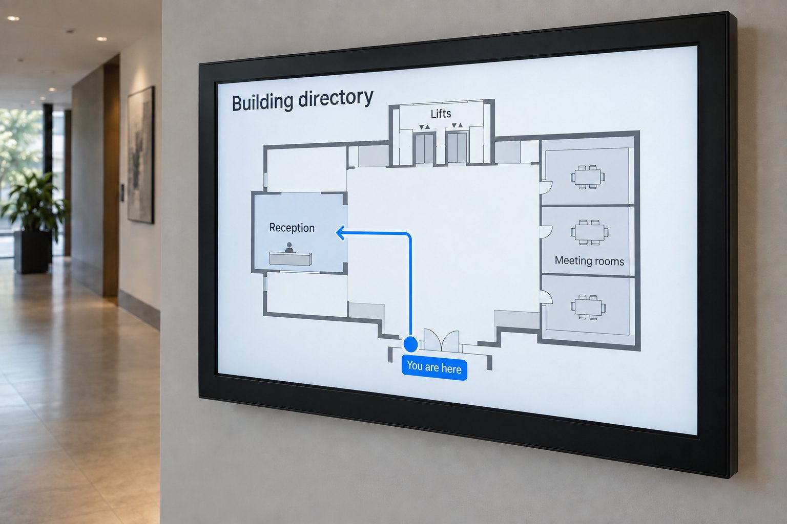 Close view of a digital directory showing a You are here marker, reception, meeting rooms and lifts on a simple floor map.
