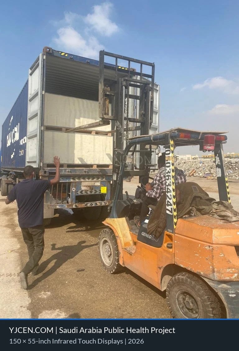 A forklift handling a wooden shipping crate at a container during the Saudi Arabian display project’s delivery process.